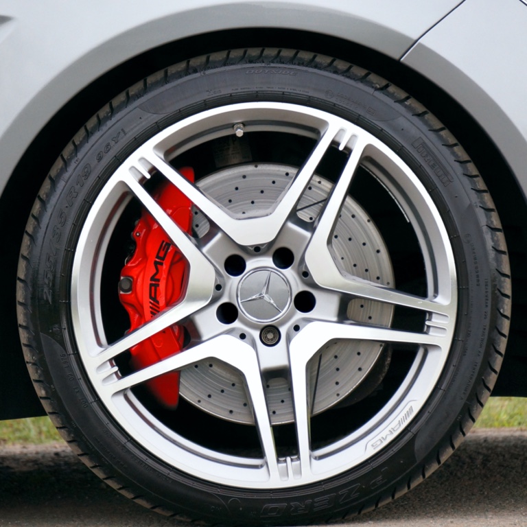 Silver Mercedes Benz five-spoke tyre rim.