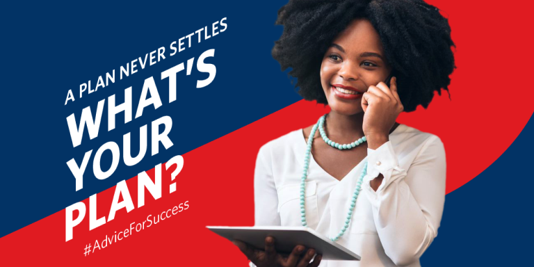 Black businesswoman smiling while looking at her laptop