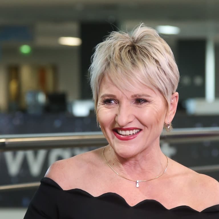 A close-up of Jeanette Marias, Momentum Metropolitan deputy CEO, wearing a black top smiling. 