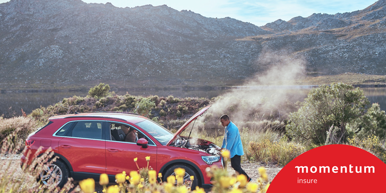 Cheslin Kolbe looking under the hood of his car as the steam escapes while his partner is in the passenger seat using the Safety Alert feature from Momentum Insure available on the Momentum App.