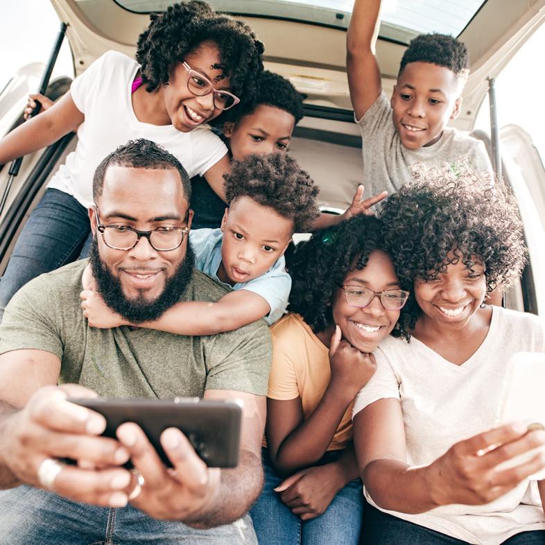 A family of 7 sitting in the boot of their SUV awaiting help from the responder as they used the Safety Alert feature that is free of charge for Momentum Insure policyholders.