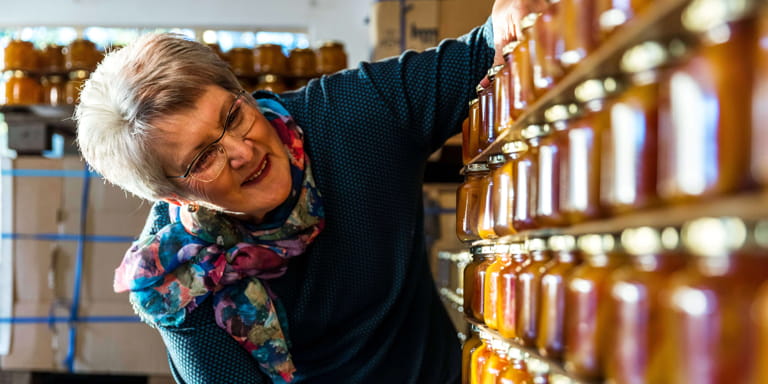 Business woman Ina Lessing, does the usual things extraordinarily well and is seen inspecting rows of freshly made jam packed on shelves.