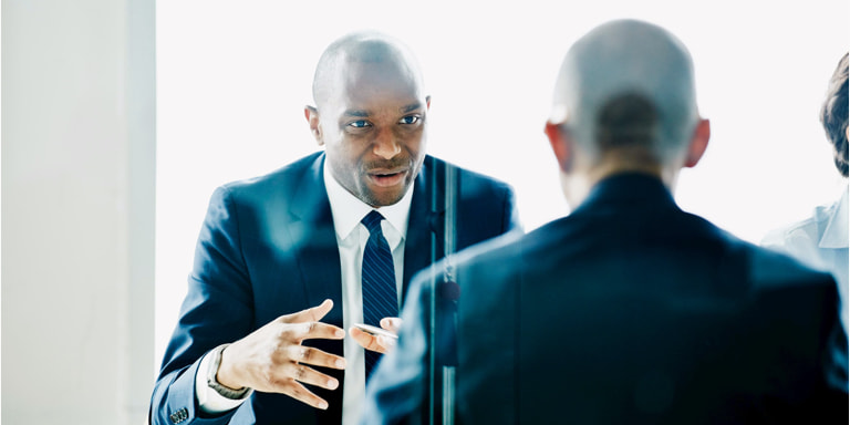 Two businessmen in suits in a discussion.