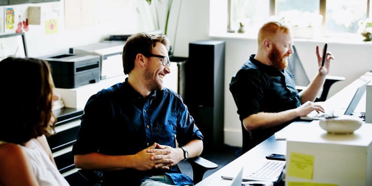 three colleagues laughing