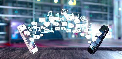 Two floating cell phones with vector icons of various social media apps floating between the two phones