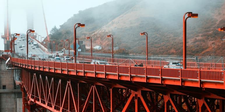 Red bridge with a misty atmosphere signifying the business transfer from Momentum Insurance to Momentum Short Term Insurance.