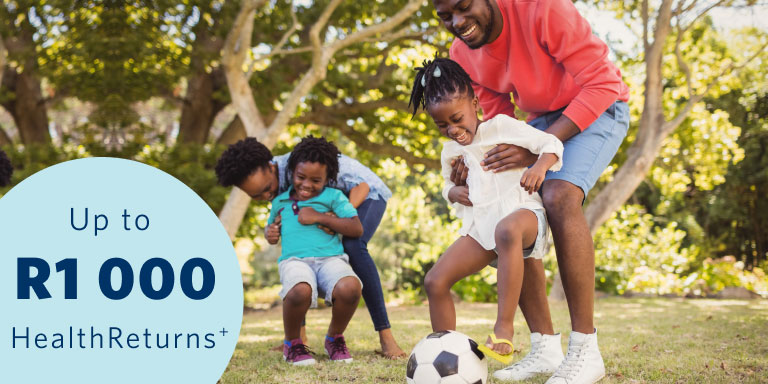 A healthy family of 4 playing outside under trees in the sunshine knowing their healthcare needs are covered by a leading and affordable medical aid.