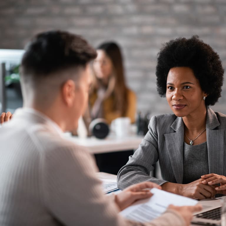 A lady speaks to her Momentum financial adviser to find out more about the Section 14 transfer that will move her pension from one fund to another.